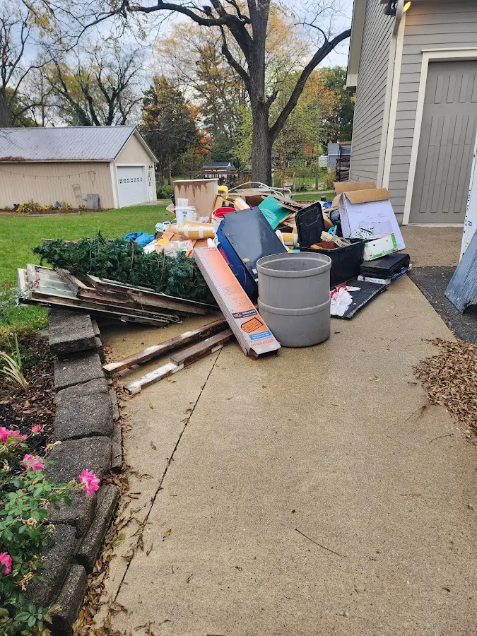 Dumpster being loaded with debris for 12 Yard Dumpster Rental in Lawrenceburg